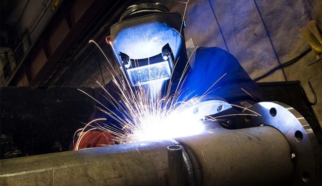 Welding welder wearing hood